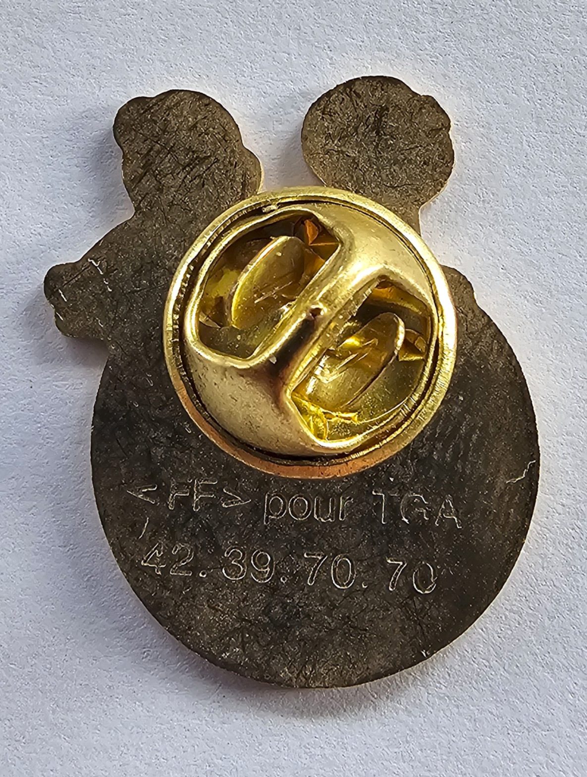 Pin's Haribo, deux enfants sur globe bleu étoilé, signé FF pour TGA — vue 2